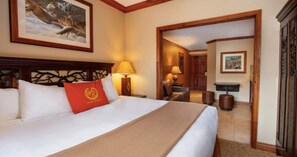 Relax in a cozy retreat with a large bed, nightstand, and comfortable seating area.