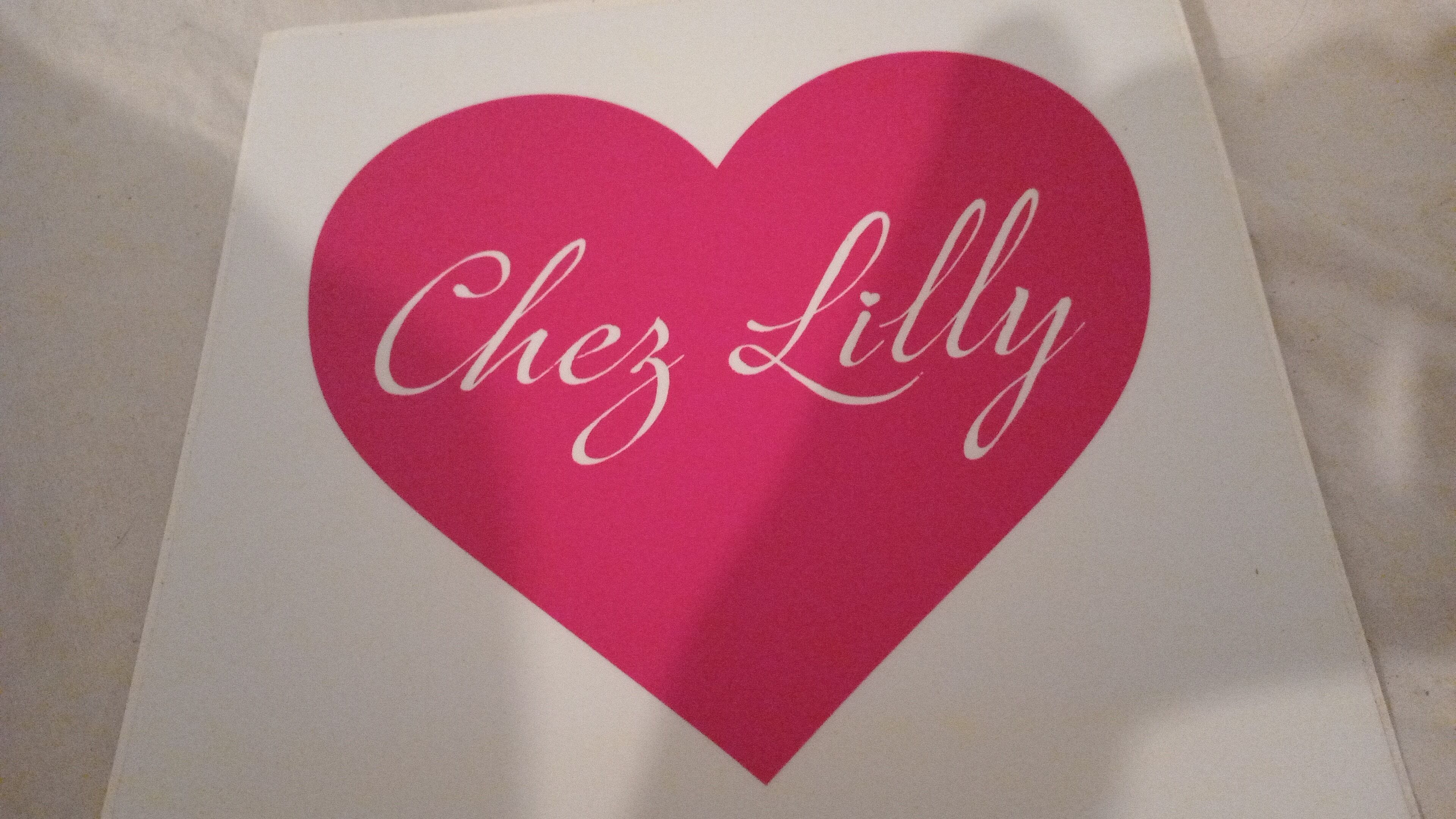 A heart-shaped sign with the name "Chez Lilly" written on it.