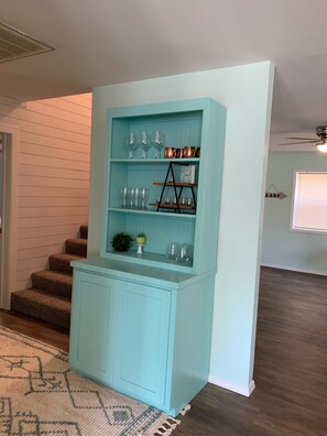 A light blue built-in shelving unit with glassware and decorative items. - Gem on Lake Tenkiller with open floor plan and game room for kids/adults. (Park hill)