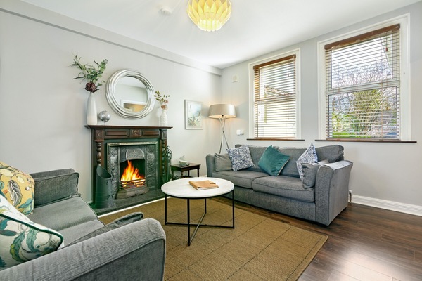 Our living room greets w/ an inviting atmosphere and warm décor.