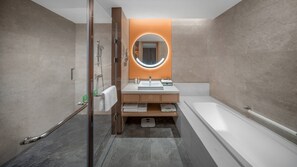A modern bathroom with a glass-enclosed shower, a vanity with a sink and mirror, and a separate bathtub. - Holiday Inn Luzhou Longjian by IHG (Luzhou)
