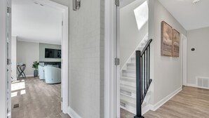 A modern interior with a staircase, a kitchen area, and a living space.