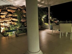 Enjoy an outdoor space with a table and chair, perfect for dining or relaxation.