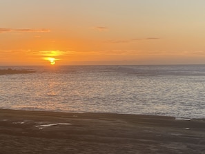 Enjoy a serene beach experience with gentle waves lapping at the shore.