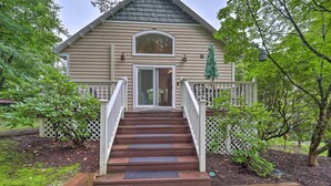 A two-story house with a front porch, a staircase, and a deck. - Quiet Studio Escape ~ 2 Mi to Blue Ridge Parkway! (West Jefferson)
