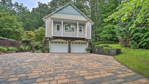 A two-story house with a front porch and two garages. - Quiet Studio Escape ~ 2 Mi to Blue Ridge Parkway! (West Jefferson)