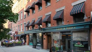 A row of brick buildings with awnings, one of which is labeled "LOUISE & JERRY'S."