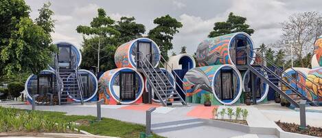 A series of colorful, cylindrical structures with external staircases, likely part of a themed attraction or park.