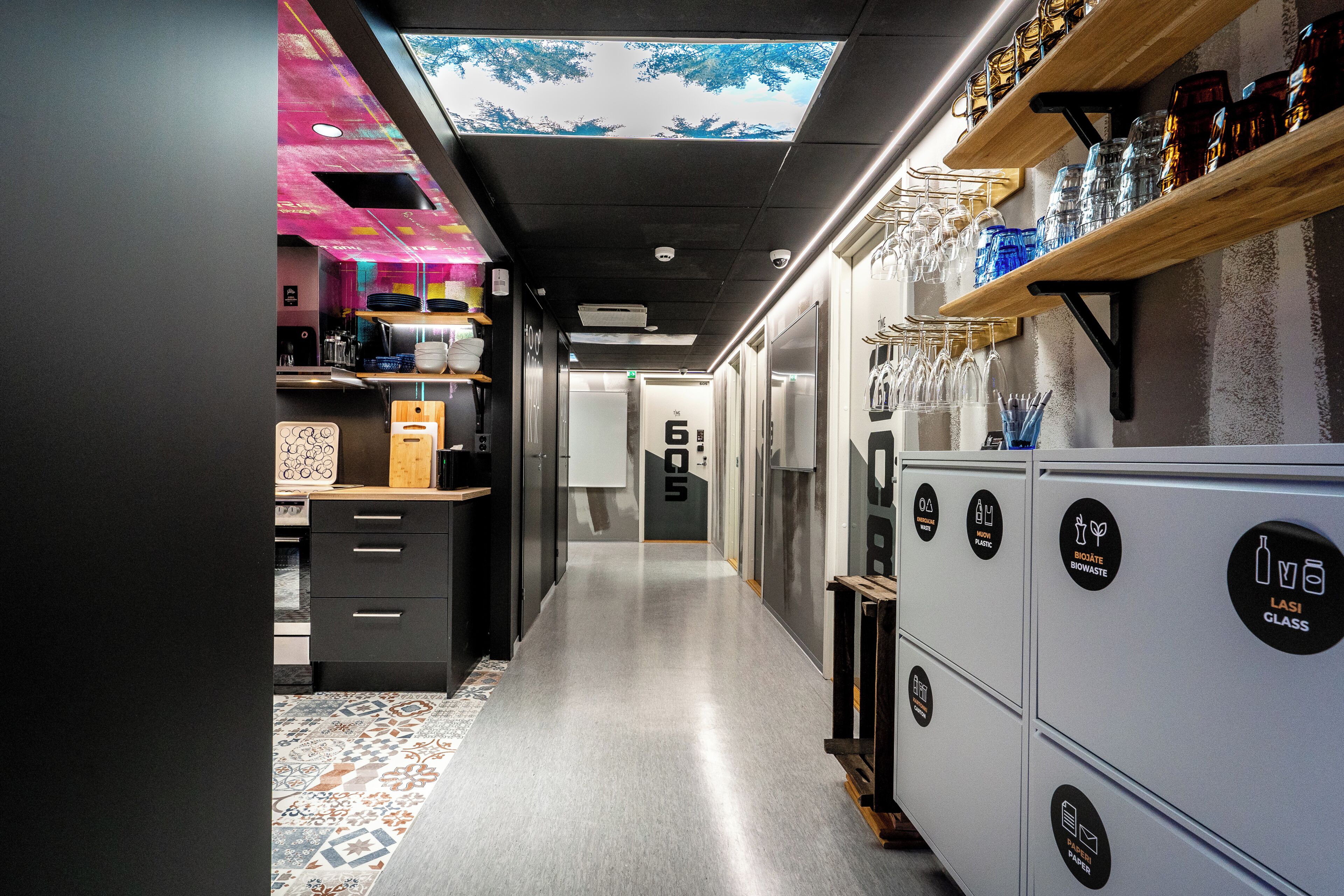A modern kitchen with a central island, a coffee machine, and a variety of kitchenware.