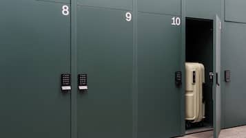 A row of green lockers numbered 8 to 10, each with a keypad lock.