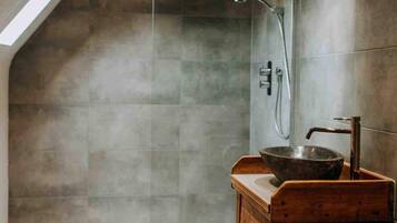 Bathtub, hair dryer, towels, toilet paper