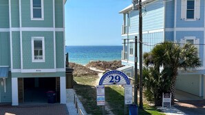 A beachfront property with a sign indicating 'Panama City Beach Public Beach Access' and a 'For Sale' sign. - Sea Escape! Stunning Gulf-View Retreat with Private Pool (Panama City Beach)