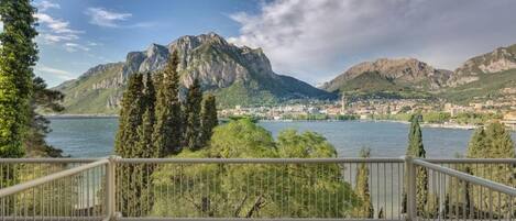 A balcony with a view of a lake and mountains.