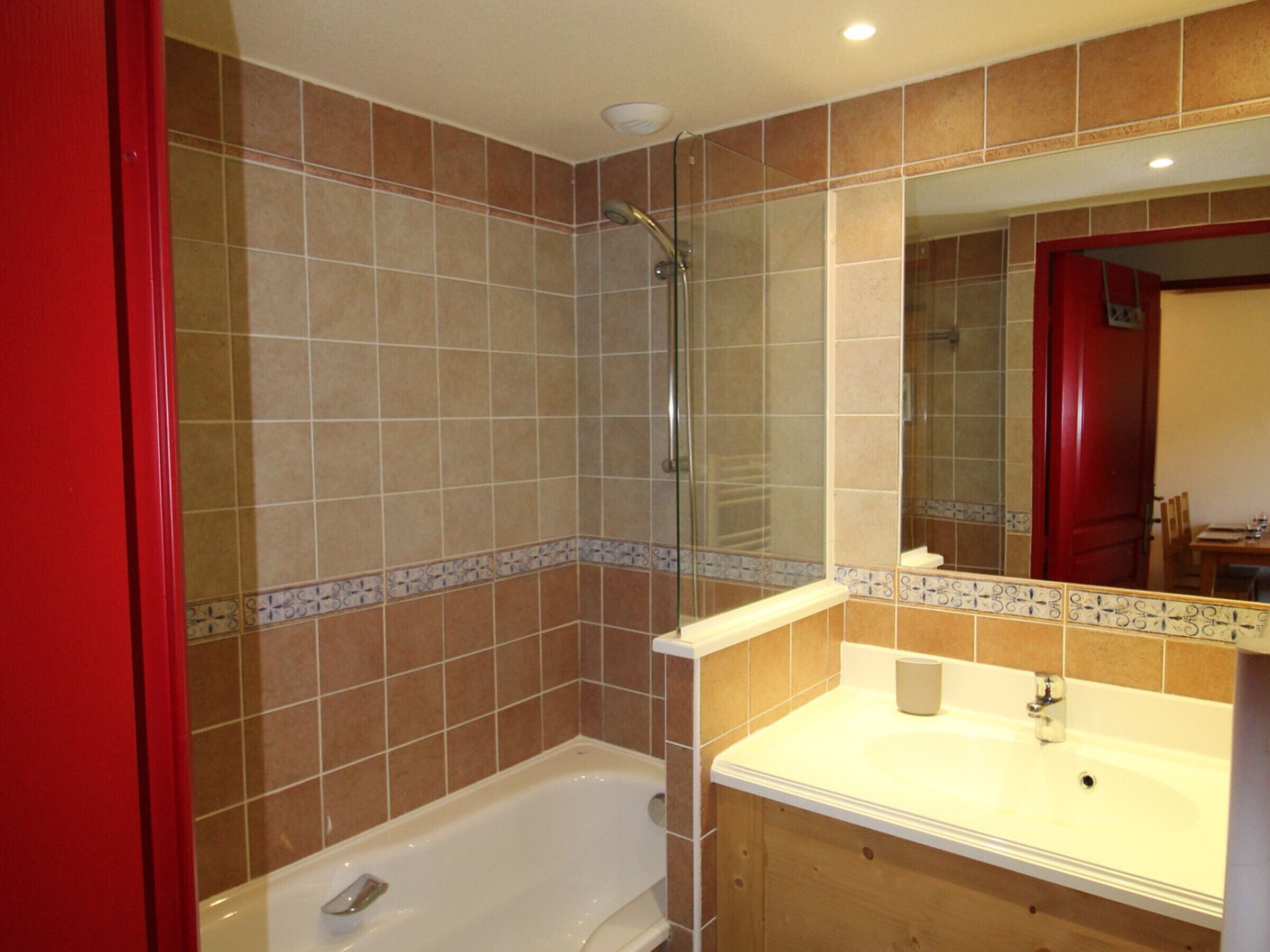 A bathroom with a bathtub, a sink, and a shower.