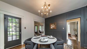 A dining area with a round table, dark walls, and a chandelier. - Hip and Historic Home Awaits You!  Stroll downtown/Steps away from UCA and CBC (Conway)