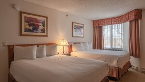 A hotel room with two beds, a lamp, and two framed artworks on the walls. - Grand Lodge 1-Bedroom Condo with 3 Queens & Close to Everything 1 Condo - No Cleaning Fee! by RedAwning (Crested Butte)