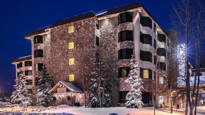 A multi-story hotel with a stone facade, multiple balconies, and a snow-covered entrance. - Grand Lodge Condo In The Heart Of Mt Crested Butte 1 Bedroom Condo - No Cleaning Fee! by RedAwning (Crested Butte)