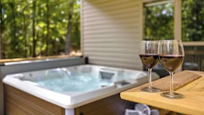 A hot tub with two glasses of wine on a wooden table. - OZ Adventure Retreat-Explore *Ride*Relax*Repeat (Bella Vista)
