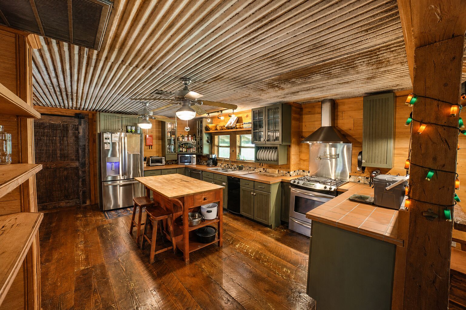 A kitchen with wooden cabinets, a central island, and a ceiling fan.