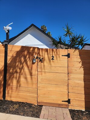 Secure entry point with a black latch, part of a well-maintained outdoor space.