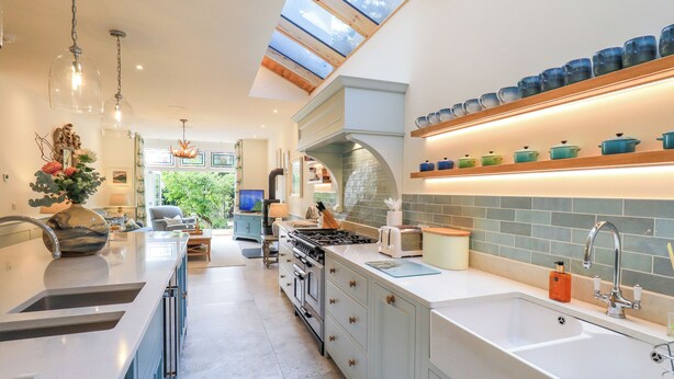 A spacious kitchen with a central island, a built-in oven, and a large window above the sink. - Fern Bank (Penrith)