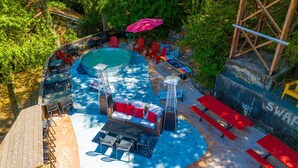 An outdoor swimming pool area with a hot tub, lounge chairs, and picnic tables. - 《Best Austin Location ❤Huge Patio w HEATED Cowboy Pool & 65" TV❤ Skyline Views》 (Austin)