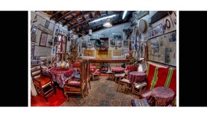 A traditional room with wooden furniture, a fireplace, and various wall decorations.