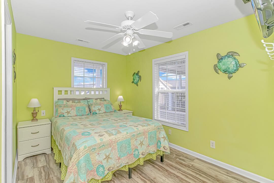 Another view of queen bed in yellow room