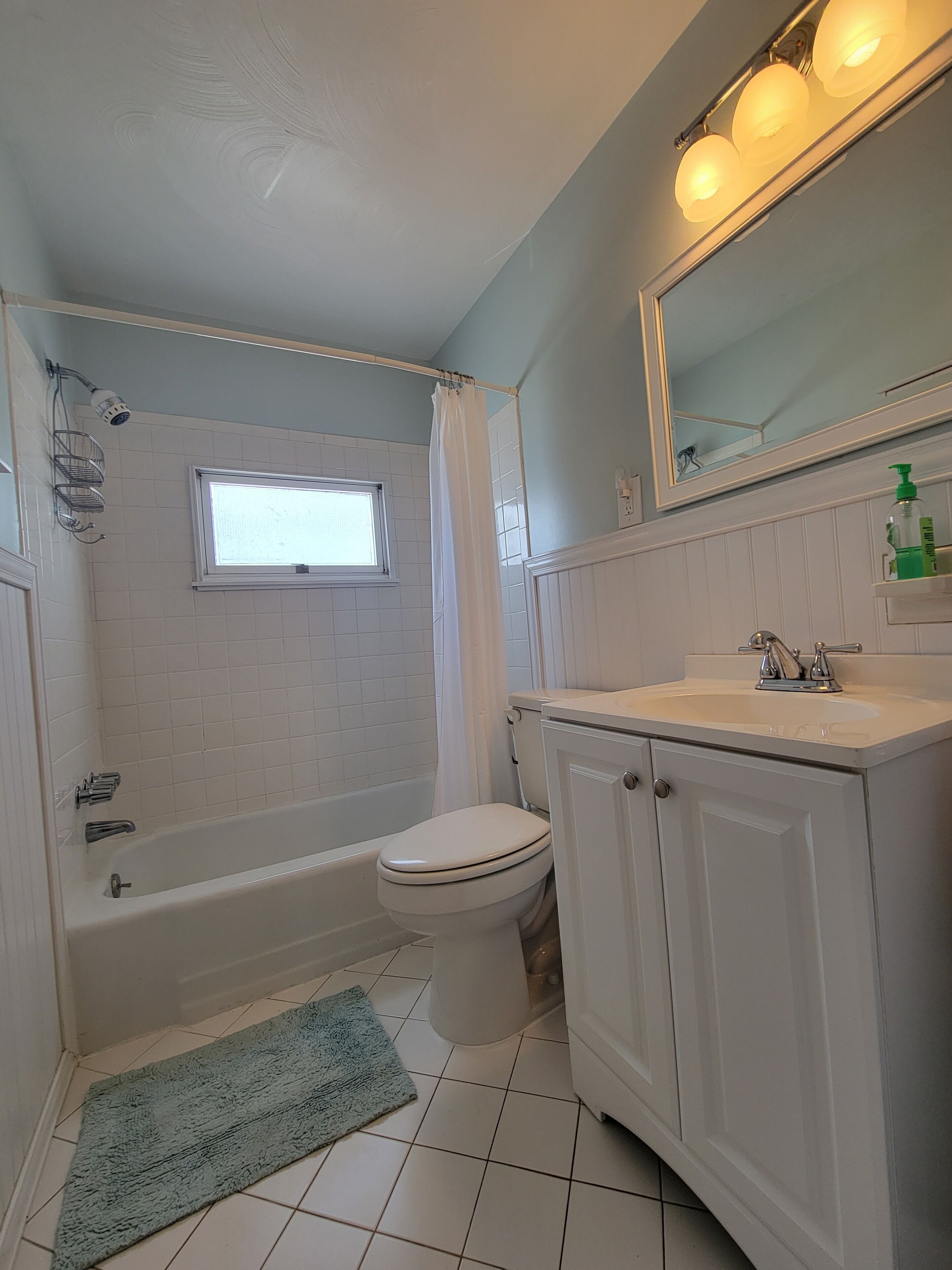 A bathroom with a bathtub, toilet, and sink.