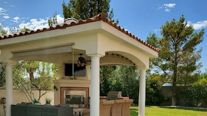 A covered patio with outdoor furniture, a fire pit, and a pergola structure. - PRIVATE OASIS-MONTHLY RENTAL/ POOL/SPA/GOLF/WIFI/PARKING/REVIEWS! (Las Vegas)