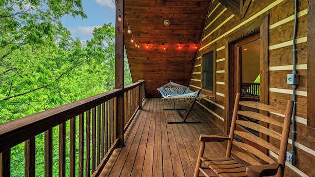 A wooden deck with a hammock and a bench, overlooking a forested area. - Location! Hot Tub, Game Room, Playground, 2K+ Sq Feet, Easy Roads! (Gatlinburg)