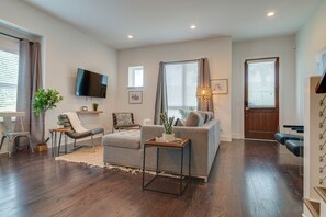 Relax in this cozy living space with a flat-screen TV, comfortable sofa, and a chair.
