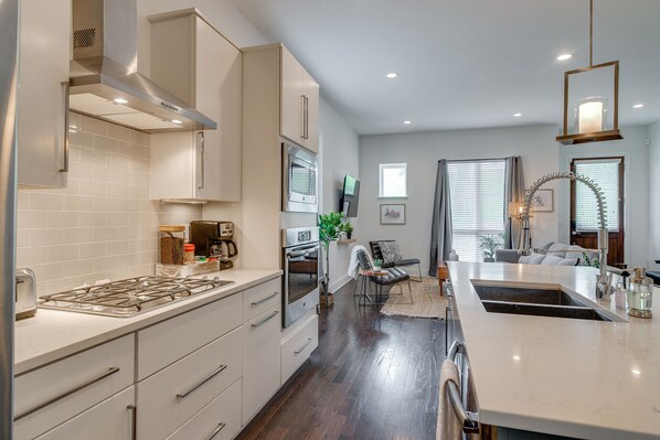 Enjoy cooking in this well-equipped kitchen with a central island, stainless steel range hood, and dining area.