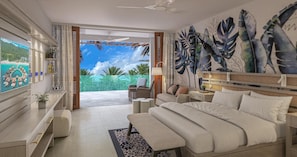 A modern bedroom with a large bed, a desk, a chair, and a view of the outdoors.
