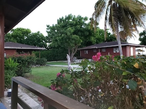 Two charming homes surrounded by lush greenery and a well-manicured lawn.