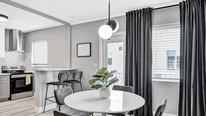 A modern kitchen with white cabinets, a built-in oven, and a stainless steel range hood. - Madison Suite 2 BD/2BA Miami Beach Lincoln Casa (Miami Beach)