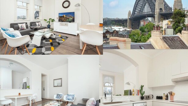 A modern living room with a TV, sofa, and coffee table. It includes a dining area with chairs and a table. The kitchen has a sink, stove, and cabinets. The image also features a view of a bridge and buildings. - Stunning Sydney Home 9 (Millers Point)