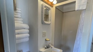 A bathroom with a toilet, sink, and shower. - Cozy Log Cabin #5 on Beautiful Canyon Ferry Lake (Helena)