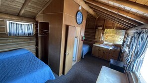 A cabin with a loft bedroom, a small kitchenette, and a bathroom. - Cozy Log Cabin #5 on Beautiful Canyon Ferry Lake (Helena)