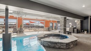 An indoor pool area with a hot tub, stone pillars, and a view of a bridge. - Stunning Lake Views, Pool, Dream Kitchen, Grill (Branson)