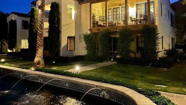 A two-story house with a balcony, a swimming pool, and a well-maintained lawn. - Stunning 2bed/2bath Villa - Amazing Location+Views (La Quinta)