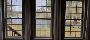 Three windows with a view of a lake and dock. - Lakefront Home- PETS, firepit, jukebox, pool table, canoe, kayak (Crossville)