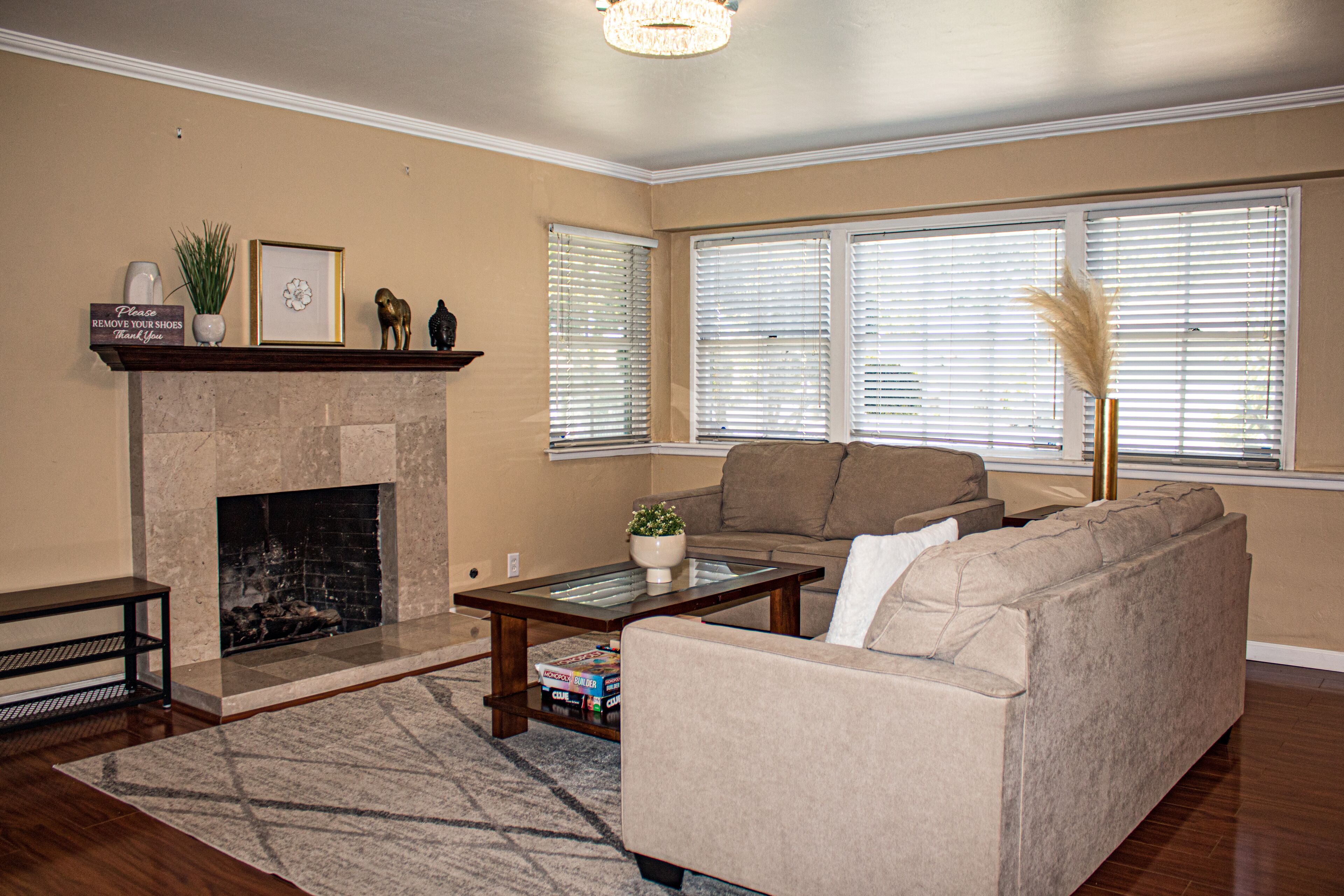 A living room with a fireplace, a sofa, a coffee table, and a bookshelf.