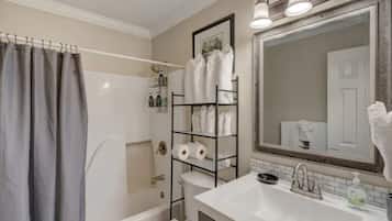 Bathtub, hair dryer, towels, soap