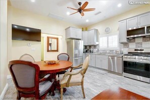 Enjoy cooking in this well-equipped kitchen with a central island, oven, and microwave.