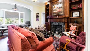 A cozy living room with a fireplace, comfortable seating, and a bookshelf. - It's Our Location...Easy to get to many Dallas Destinations (Dallas)