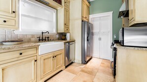 A kitchen with light wooden cabinets, a stainless steel refrigerator, a dishwasher, and a microwave. - It's Our Location...Easy to get to many Dallas Destinations (Dallas)