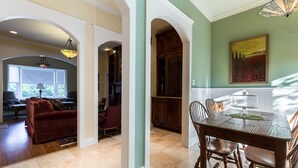 A spacious dining area with a wooden table and chairs, a chandelier, and a painting on the wall. - It's Our Location...Easy to get to many Dallas Destinations (Dallas)