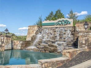 A sign for Golfview Resort with a waterfall feature. - Whispering Timbers near Dollywood. Spacious cabin w/breath-taking mountain view! (Pigeon Forge)