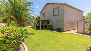 A two-story house with a covered patio, a well-maintained lawn, and a palm tree. - Walk to Stadium|Westgate|Glendale (Glendale)